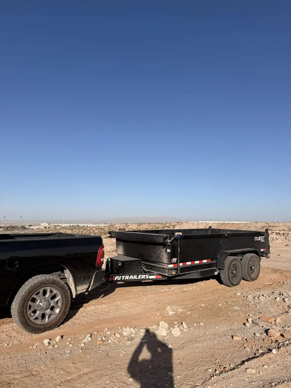 Dump trailer hitched to the truck on a desert lot